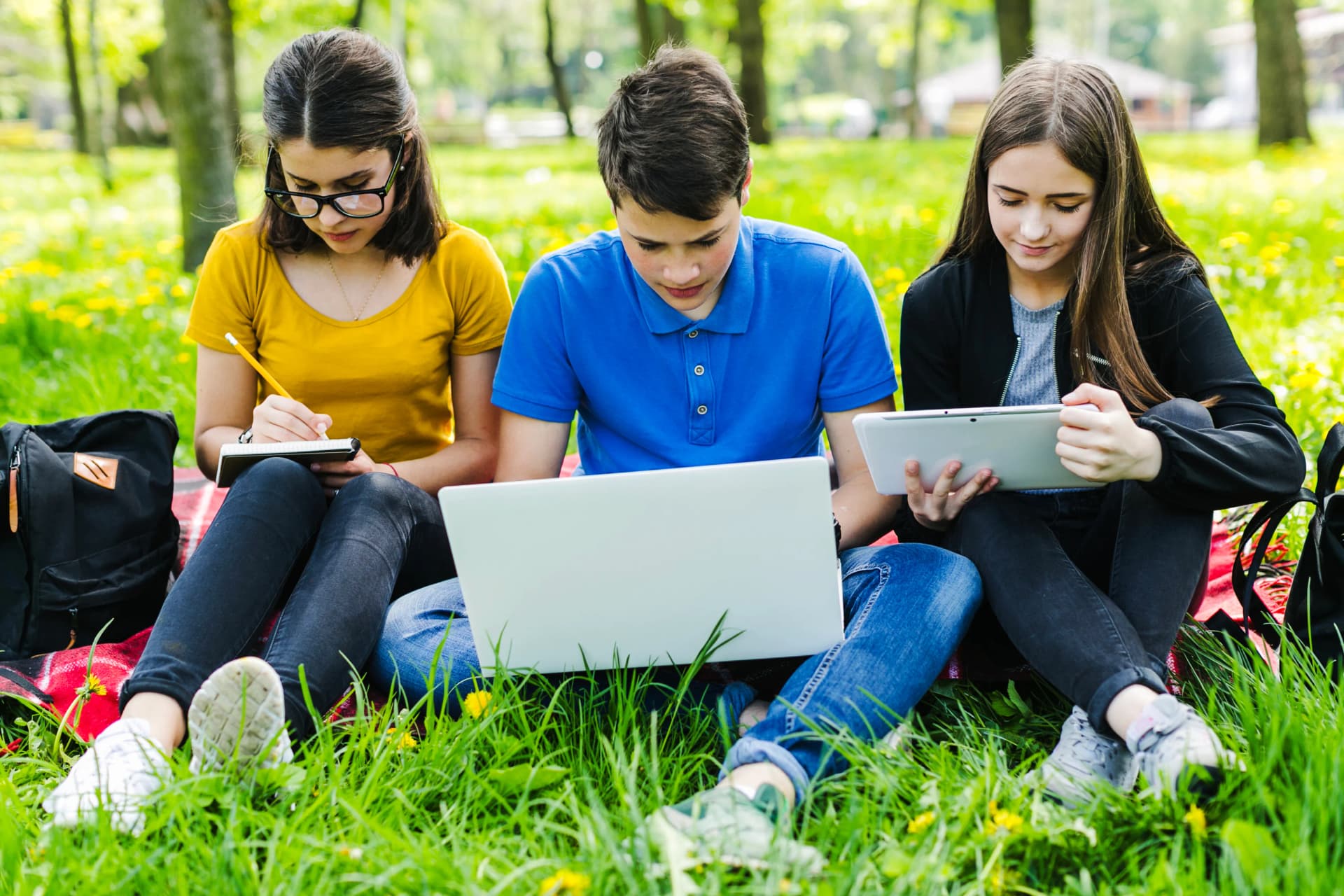 Students learning through distance education outdoors.