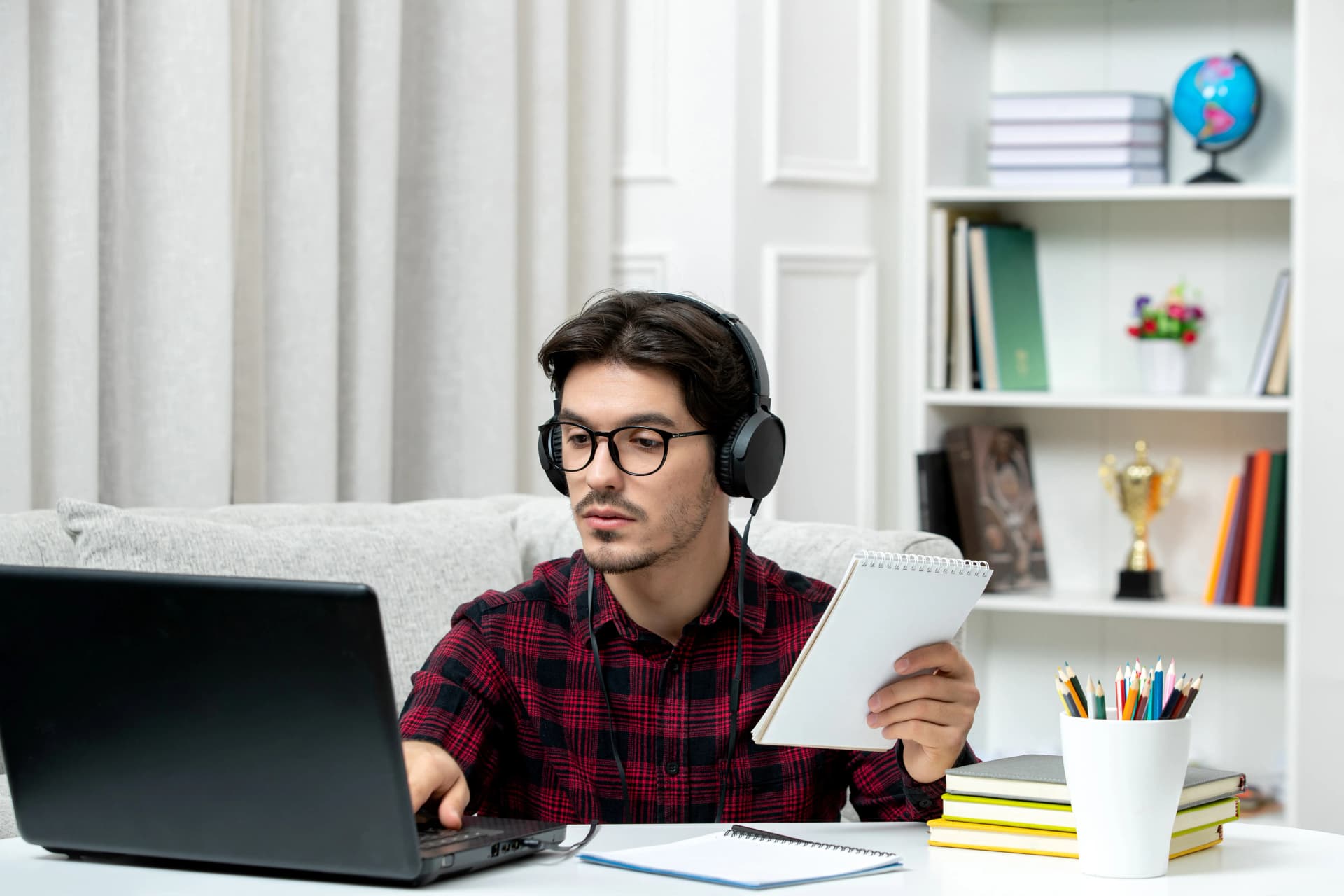 Student studying online MBA program from Manipal University at home using a laptop.